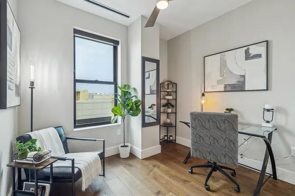 a living room with furniture and wooden floor