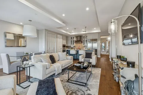 a living room with furniture kitchen view and a table