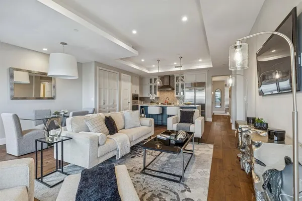 a living room with furniture kitchen view and a table
