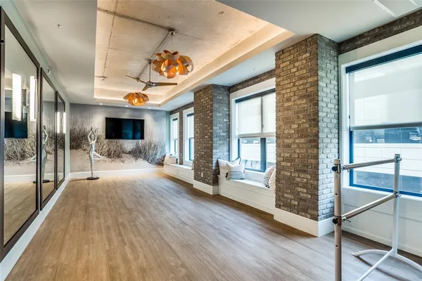 a view of an entryway with wooden floor and windows