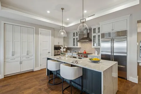 a kitchen with a sink cabinets and wooden floor
