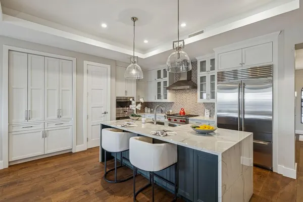 a kitchen with a sink cabinets and wooden floor
