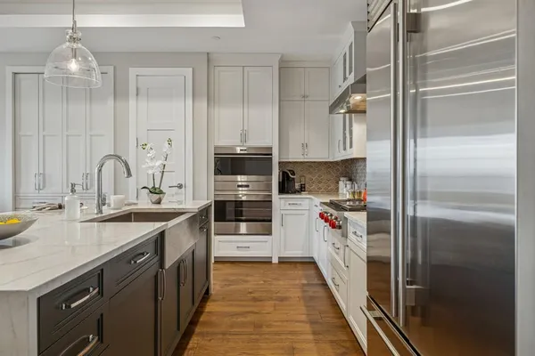 a kitchen with stainless steel appliances a sink and a refrigerator