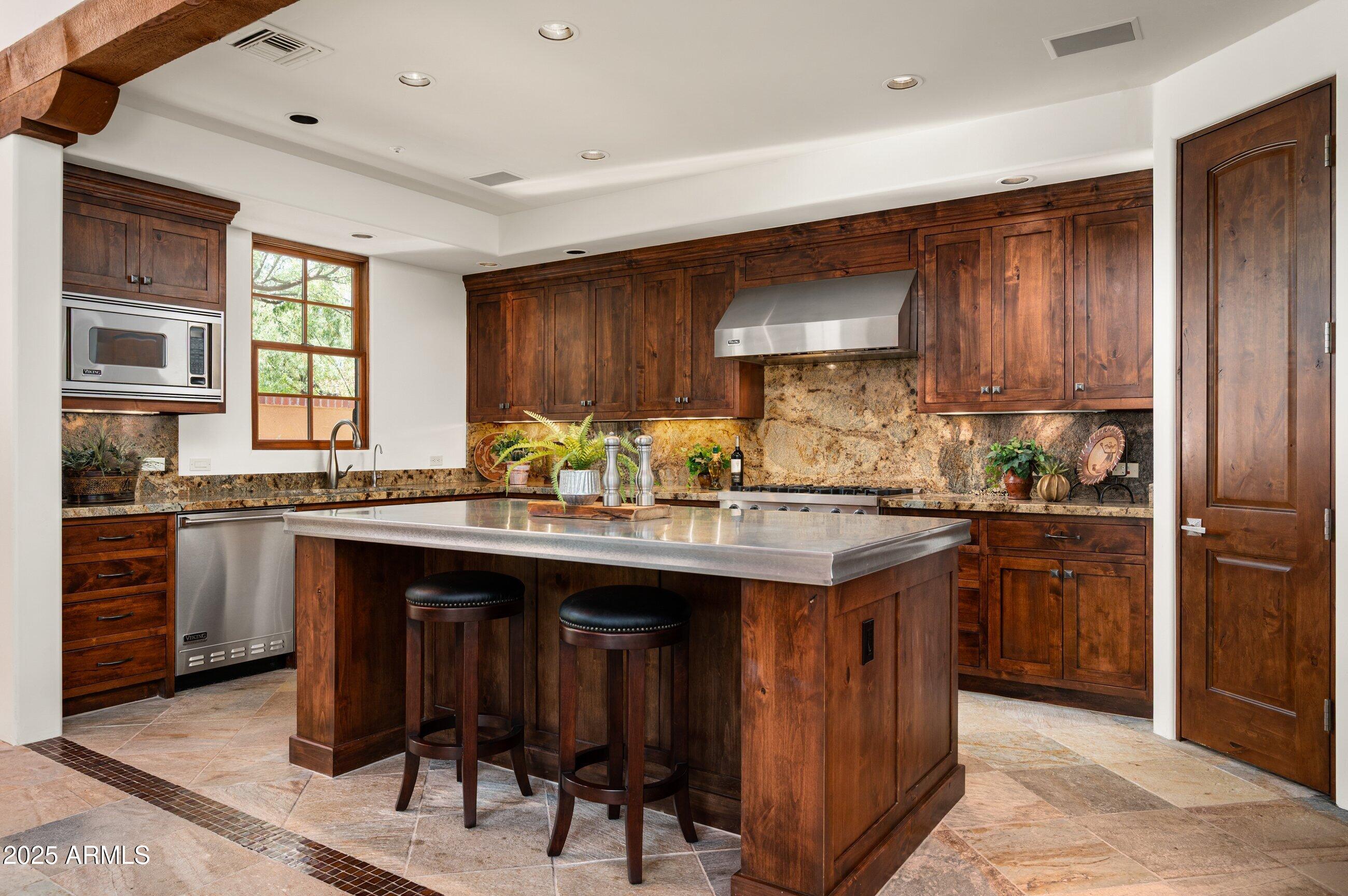 10597 East Rising Sun Drive Scottsdale, AZ 85262 - Photo 14 of 53 a kitchen with granite countertop a sink appliances and cabinets