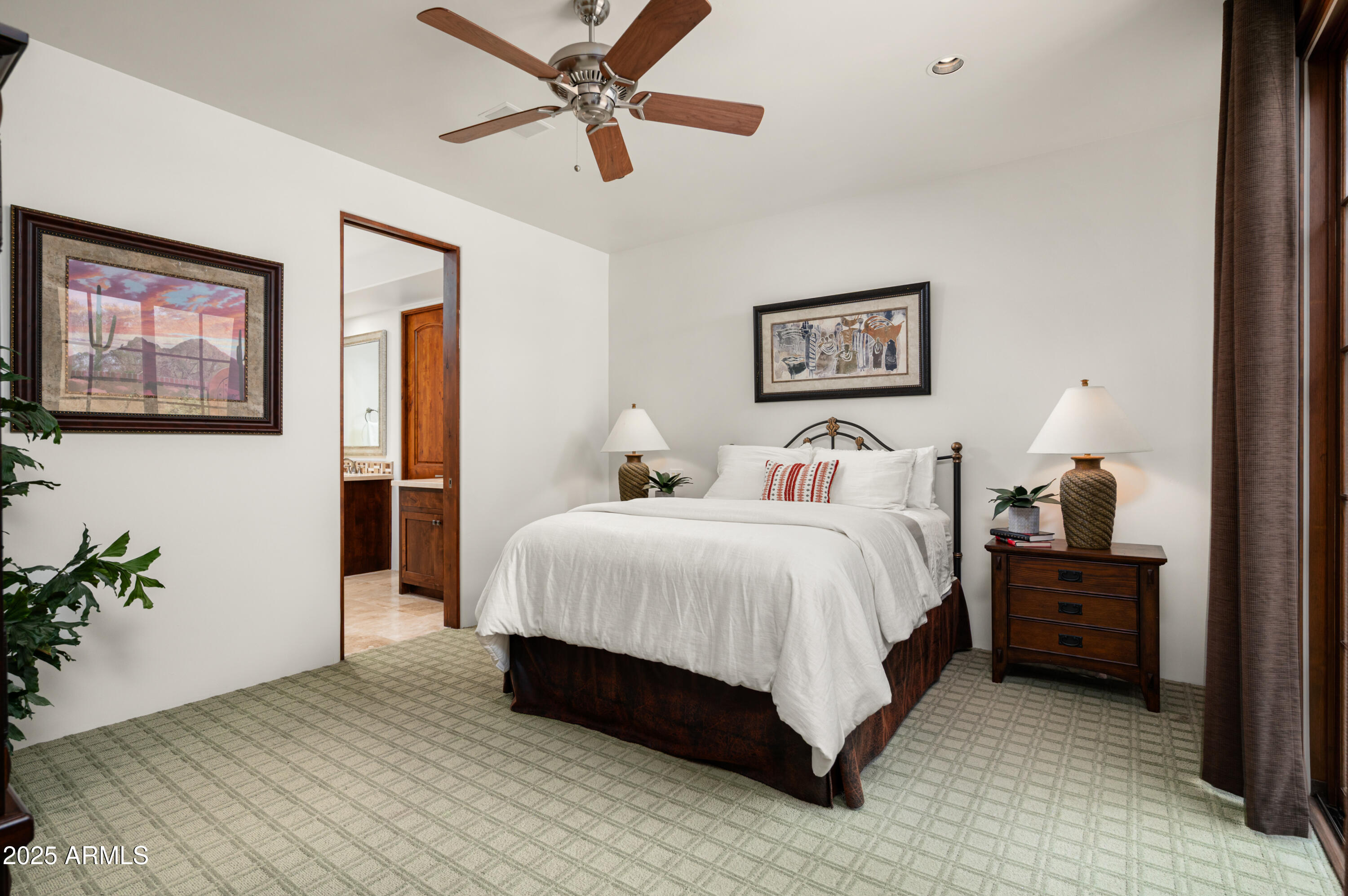 10597 East Rising Sun Drive Scottsdale, AZ 85262 - Photo 27 of 53 a spacious bedroom with a bed and a potted plant
