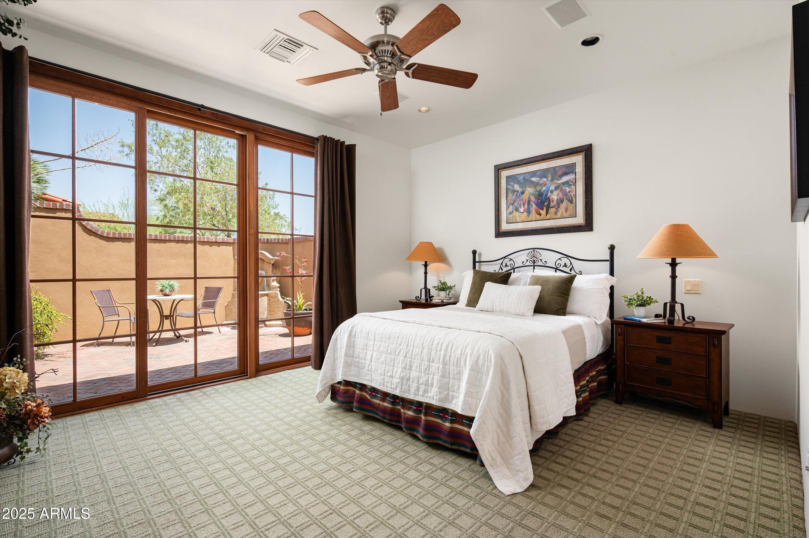 10597 East Rising Sun Drive Scottsdale, AZ 85262 - Photo 31 of 53 a spacious bedroom with a bed and a large window