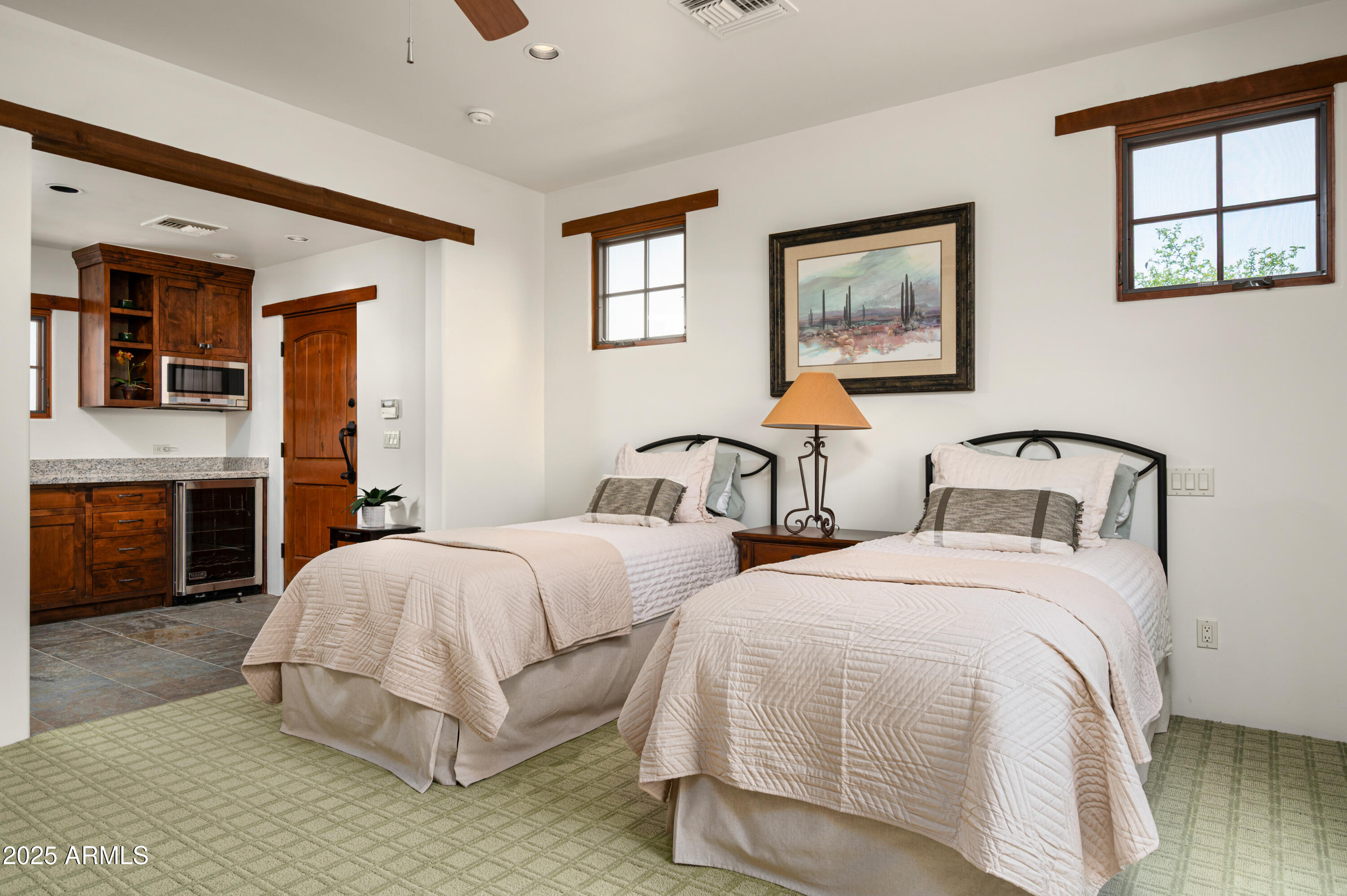 10597 East Rising Sun Drive Scottsdale, AZ 85262 - Photo 37 of 53 a bedroom with two beds and painting on the wall