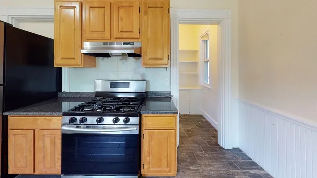 a stove top oven sitting inside of a kitchen