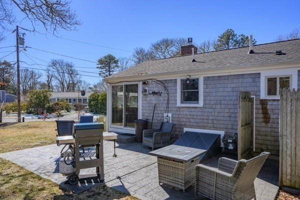 16 Hazelwood Road Dennis, MA 02660 - Photo 25 of 40 a brick house with table and chairs in front of it