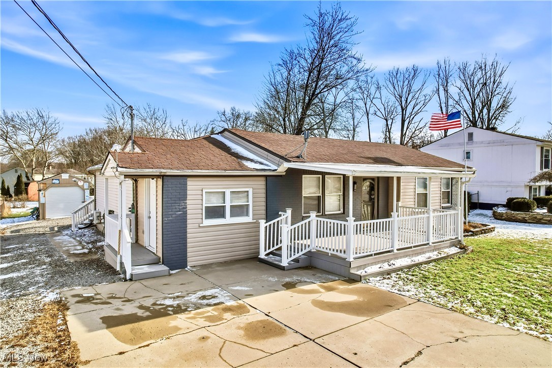 245 North Road Niles, OH 44446 - Photo 2 of 45 View of front of property featuring a deck, a shingled roof, and a patio area