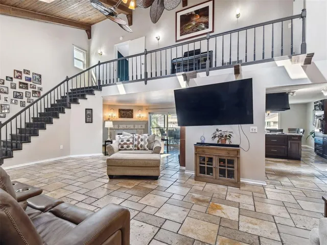 a kitchen with granite countertop lots of wooden cabinets stainless steel appliances a sink and a counter top space