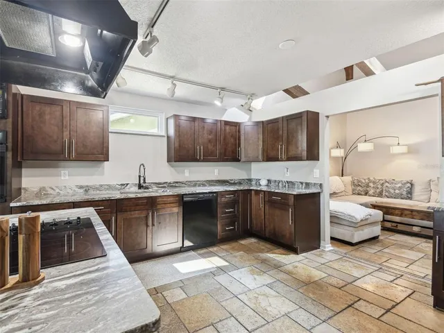 a spacious bathroom with a double vanity sink a toilet and a mirror