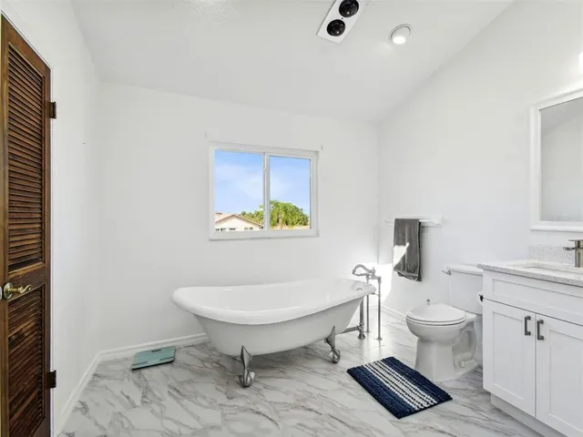 a bedroom with furniture and a large window