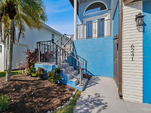 a view of a dining room with furniture a chandelier and wooden floor