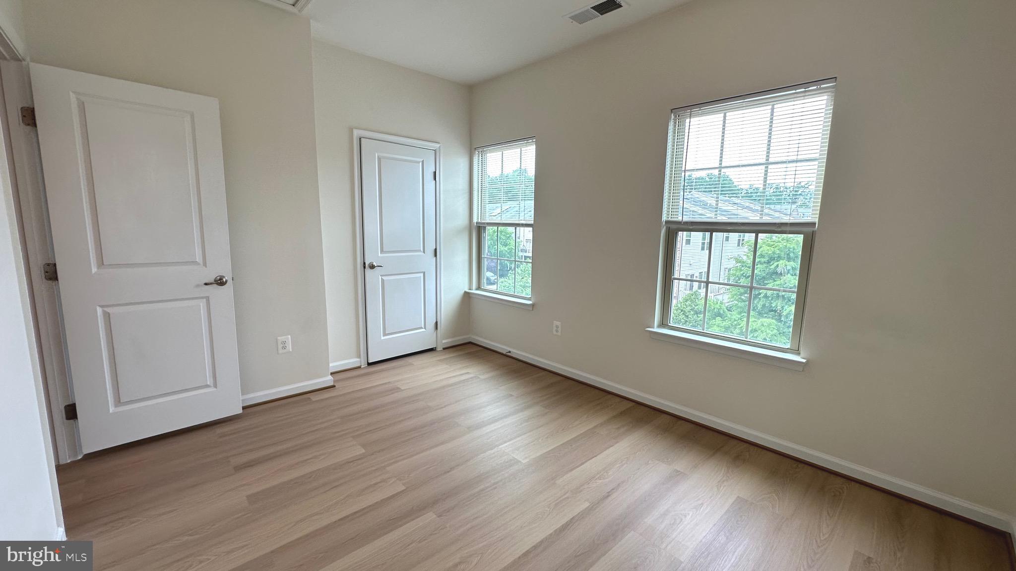 7343 Old Calvary Road Hanover, MD 21076 - Photo 27 of 35 a view of an empty room with wooden floor and a window