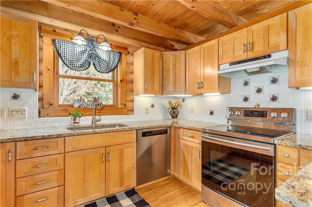 40 Yarrow Road Waynesville, NC 28785 - Photo 11 of 25 a kitchen with a stove a sink and a microwave