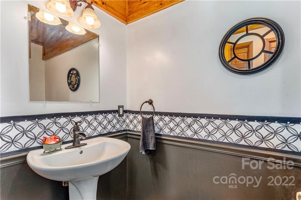 40 Yarrow Road Waynesville, NC 28785 - Photo 12 of 25 a bathroom with a sink and a mirror
