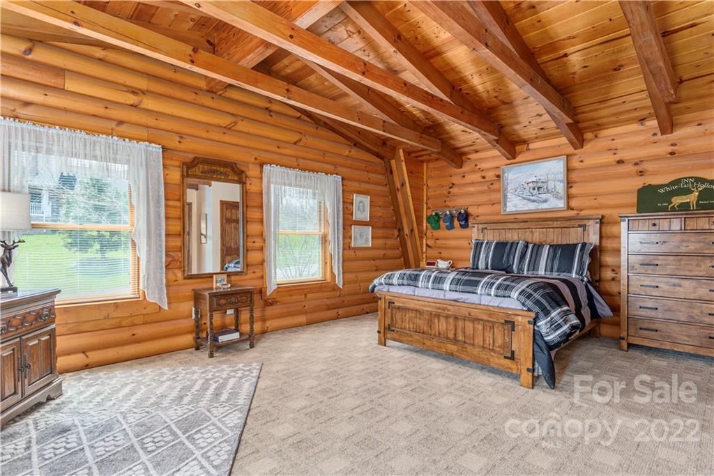 40 Yarrow Road Waynesville, NC 28785 - Photo 17 of 25 a bedroom with furniture and large windows