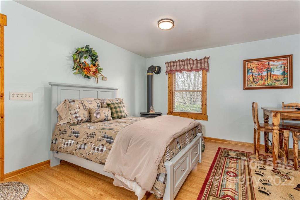 40 Yarrow Road Waynesville, NC 28785 - Photo 20 of 25 a bedroom with a bed and wooden floor