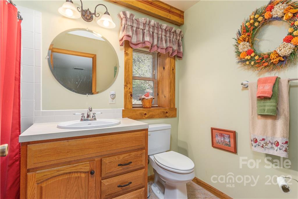 40 Yarrow Road Waynesville, NC 28785 - Photo 23 of 25 a bathroom with a toilet sink and mirror