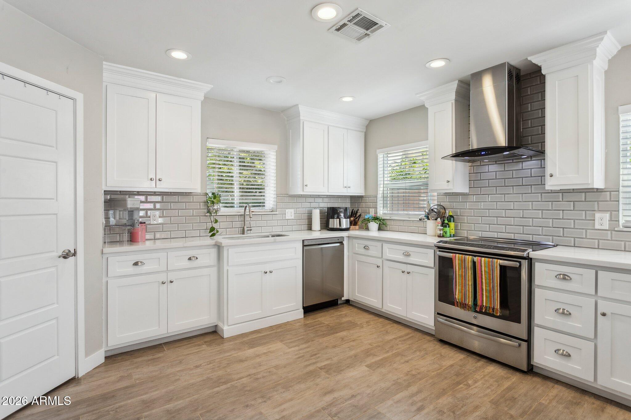 322 West Coronado Road Phoenix, AZ 85003 - Photo 12 of 93 a kitchen with white cabinets appliances a sink and a window