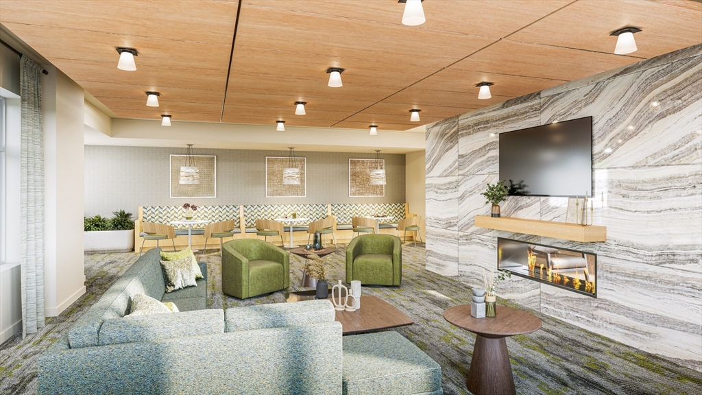 201 Sherman Road, Unit 515 Brookline, MA 02467 - Photo 4 of 26 a living room with lots of furniture and a flat screen tv