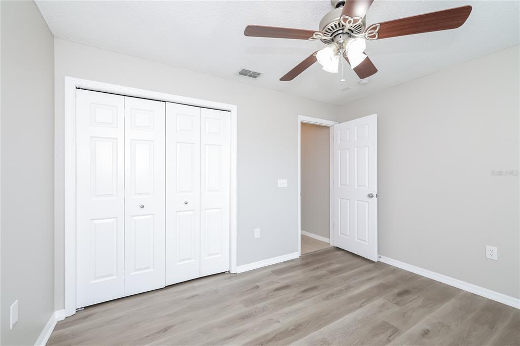 102 Ashley Loop Davenport, FL 33837 - Photo 11 of 16 wooden floor in an empty room