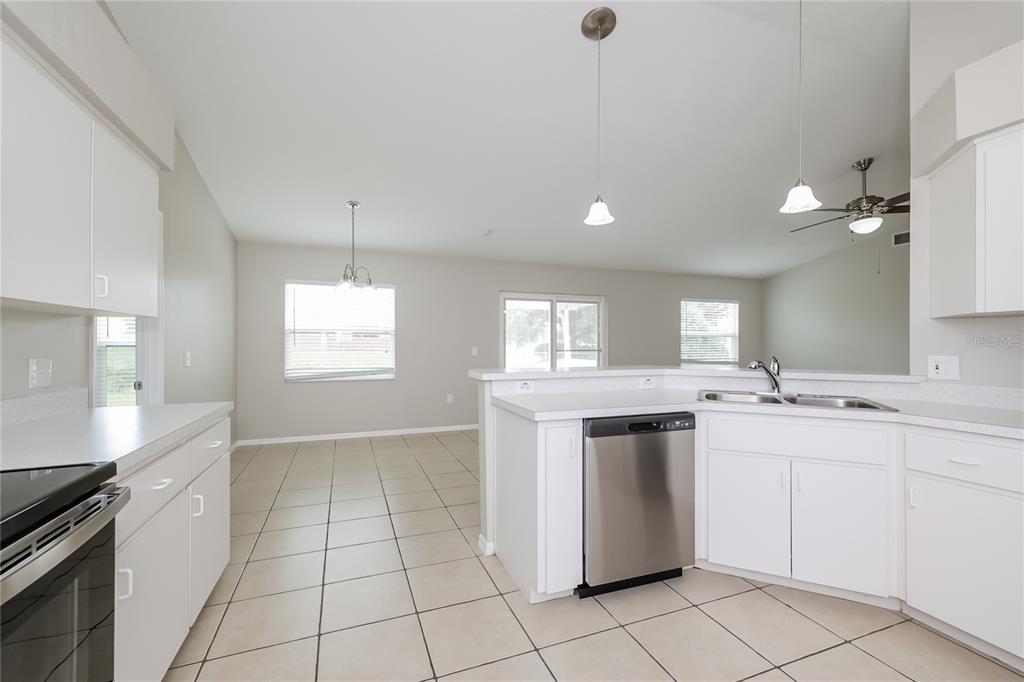 102 Ashley Loop Davenport, FL 33837 - Photo 5 of 16 a kitchen with a sink cabinets and window