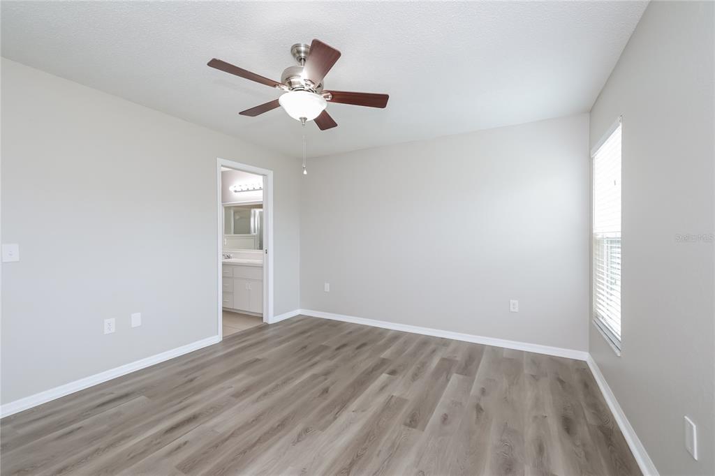 102 Ashley Loop Davenport, FL 33837 - Photo 9 of 16 a view of a room with wooden floor closet and windows