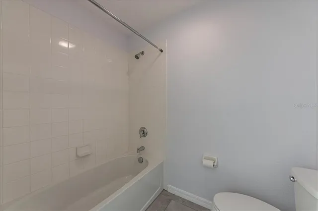 a view of a bathroom with a tub and toilet