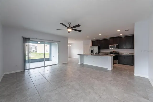 a view of kitchen with refrigerator and microwave