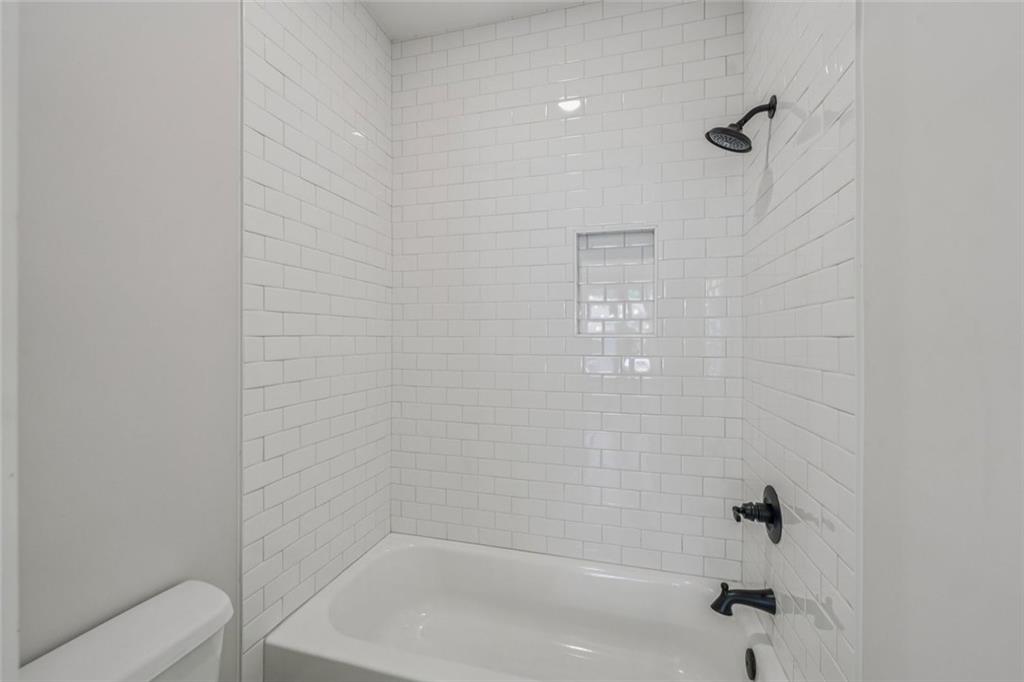 1179 Booker Avenue Southwest Atlanta, GA 30310 - Photo 24 of 54 a bathroom with a shower and toilet