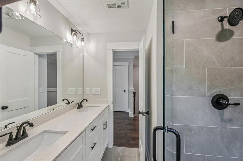 1179 Booker Avenue Southwest Atlanta, GA 30310 - Photo 30 of 54 a bathroom with a double vanity sink mirror and shower