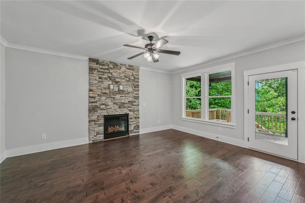 1179 Booker Avenue Southwest Atlanta, GA 30310 - Photo 8 of 54 an empty room with windows and a fireplace