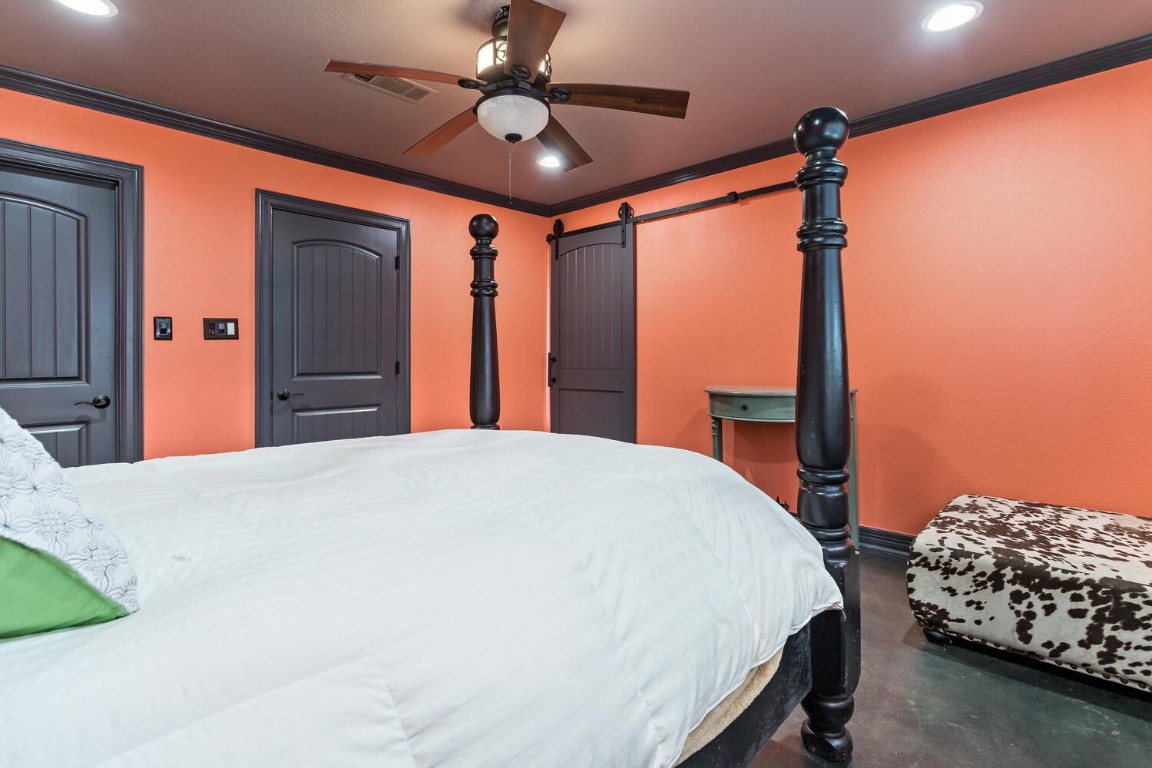 909 Turner Road Beaumont, TX 77713 - Photo 18 of 43 a bedroom with a bed and a chandelier