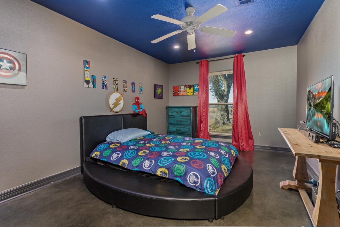 909 Turner Road Beaumont, TX 77713 - Photo 23 of 43 a bedroom with a bed and a flat screen tv