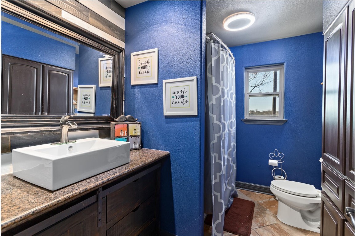 909 Turner Road Beaumont, TX 77713 - Photo 24 of 43 a bathroom with a sink a toilet and mirror
