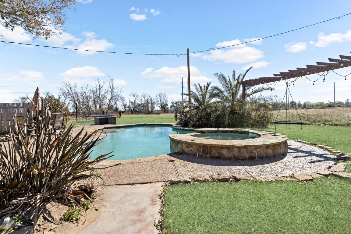 909 Turner Road Beaumont, TX 77713 - Photo 27 of 43 a view of a swimming pool with a lake