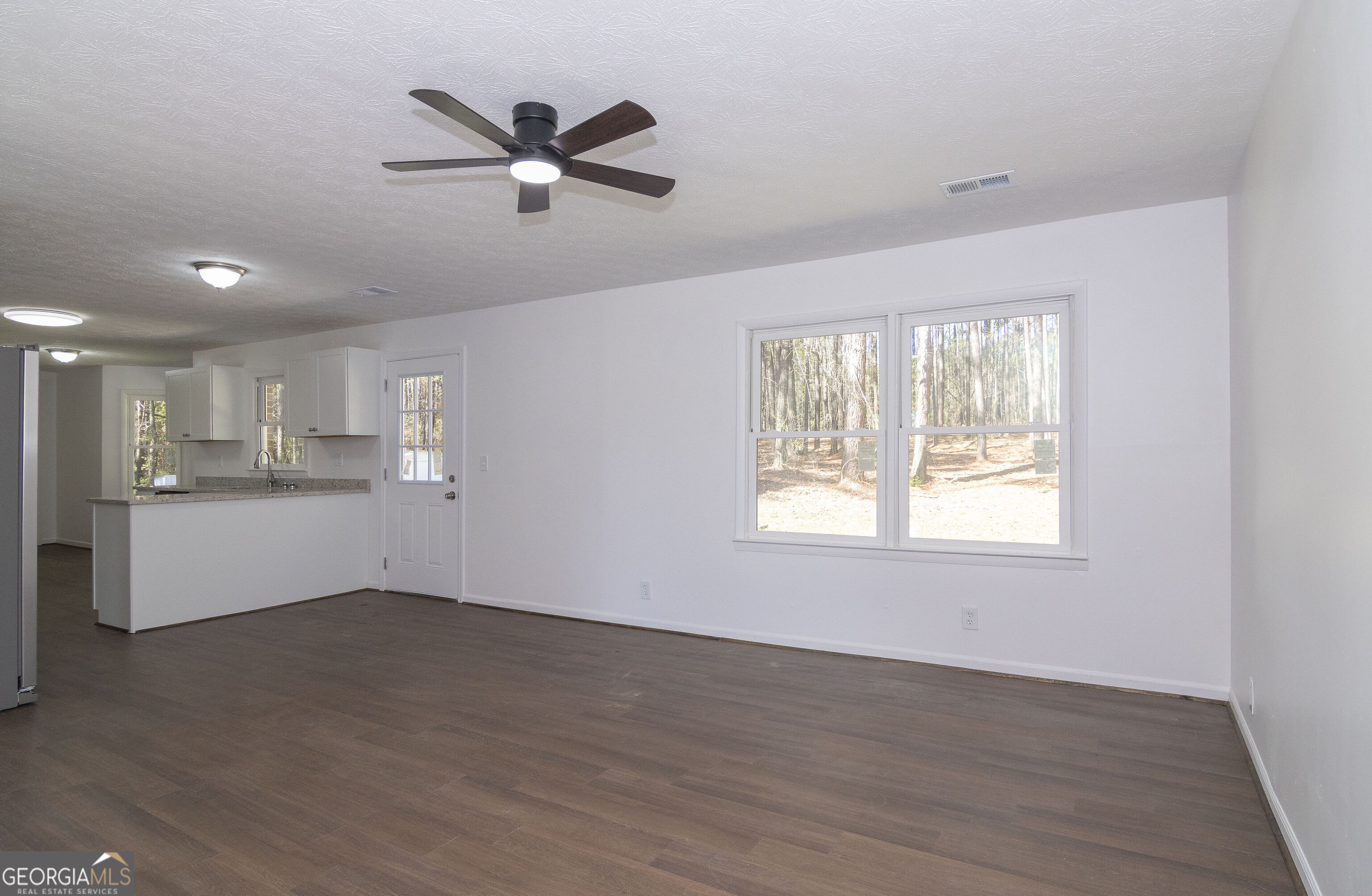 331 Deerfield Road Hogansville, GA 30230 - Photo 14 of 62 a view of an empty room with wooden floor and a window