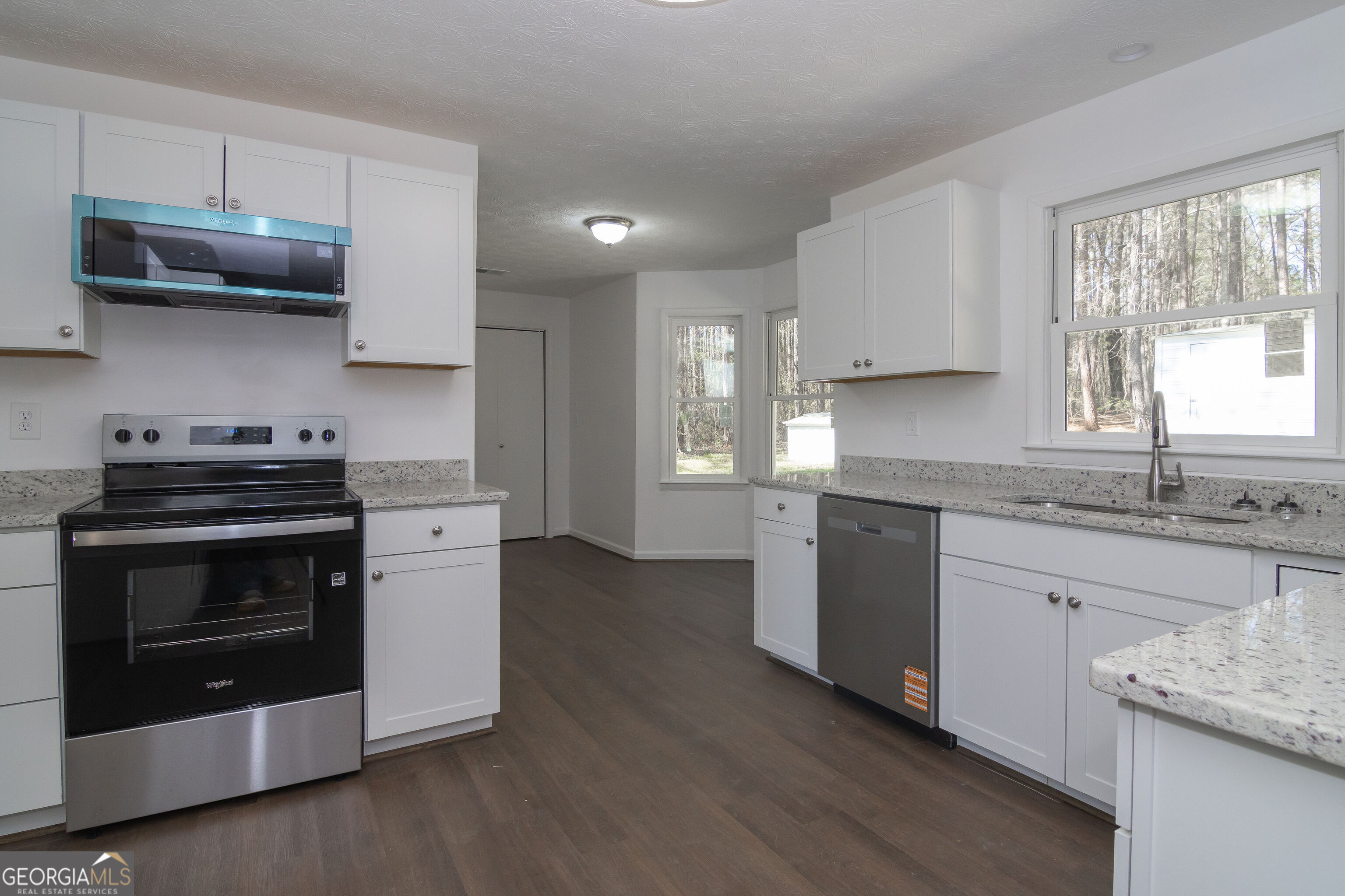 331 Deerfield Road Hogansville, GA 30230 - Photo 18 of 62 a kitchen with stainless steel appliances granite countertop a stove a sink and a microwave