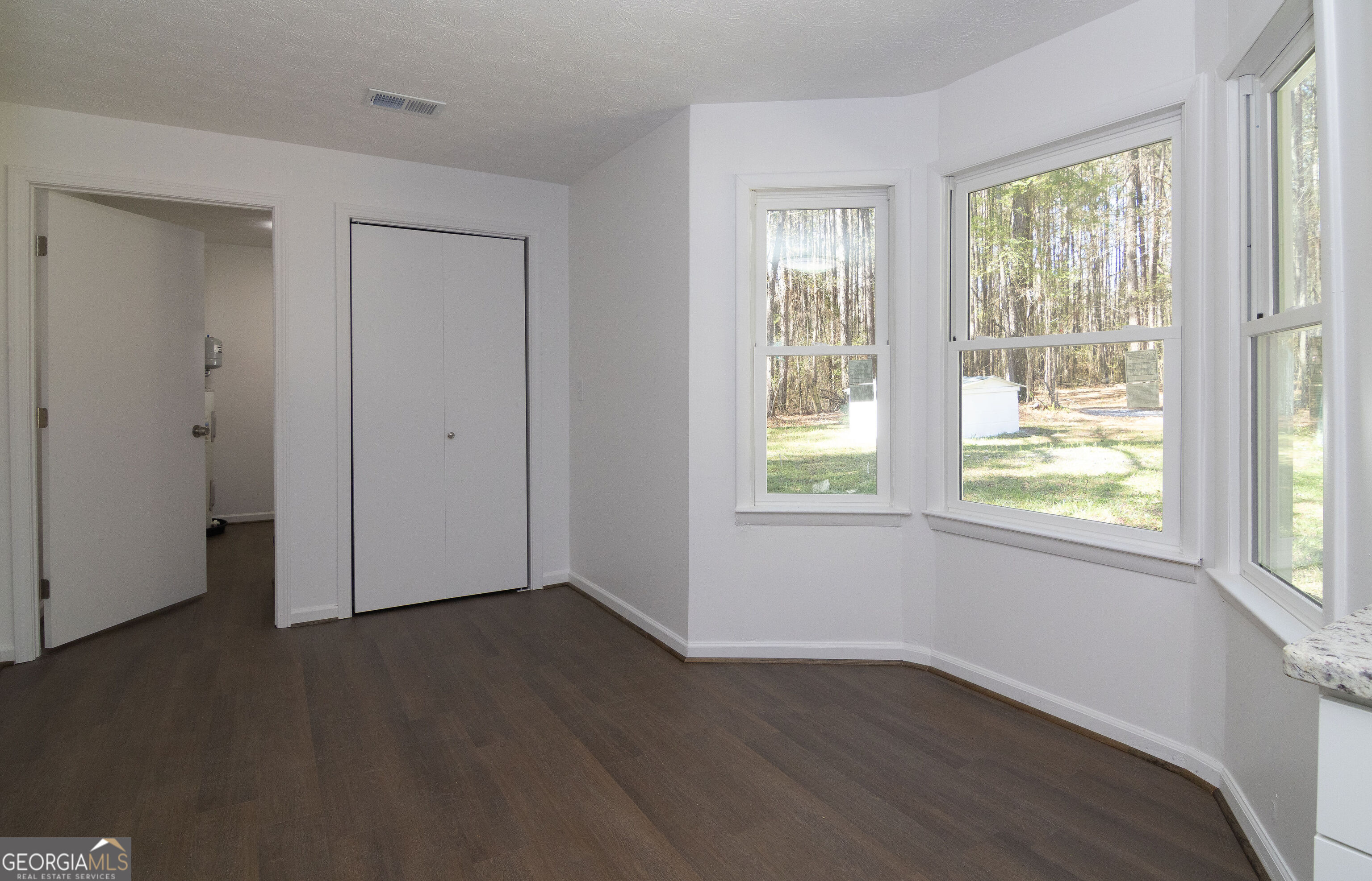 331 Deerfield Road Hogansville, GA 30230 - Photo 24 of 62 a view of an empty room with wooden floor and a window