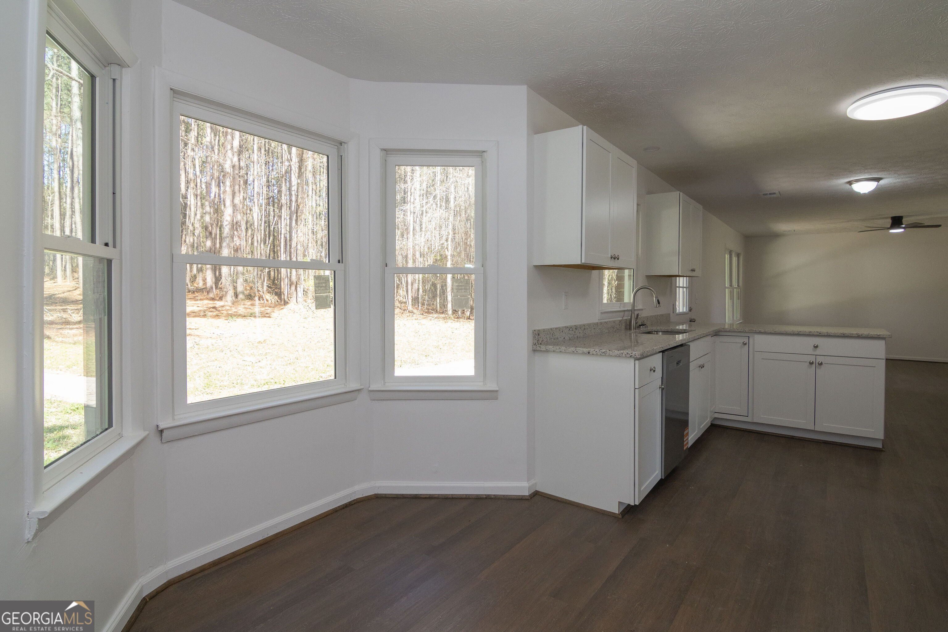 331 Deerfield Road Hogansville, GA 30230 - Photo 25 of 62 a kitchen with cabinets wooden floor and a sink