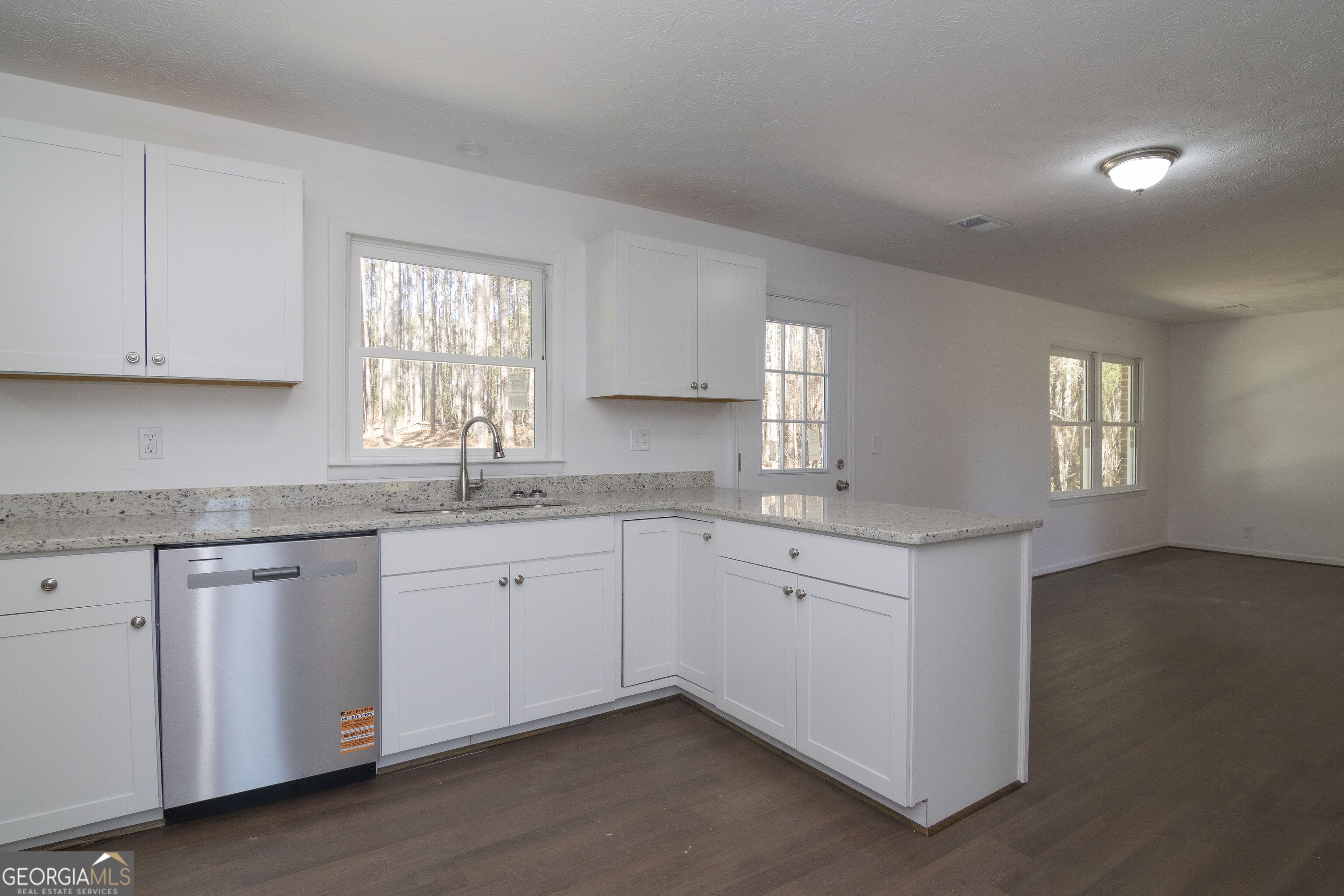 331 Deerfield Road Hogansville, GA 30230 - Photo 28 of 62 a kitchen with granite countertop white cabinets white appliances a sink and a window