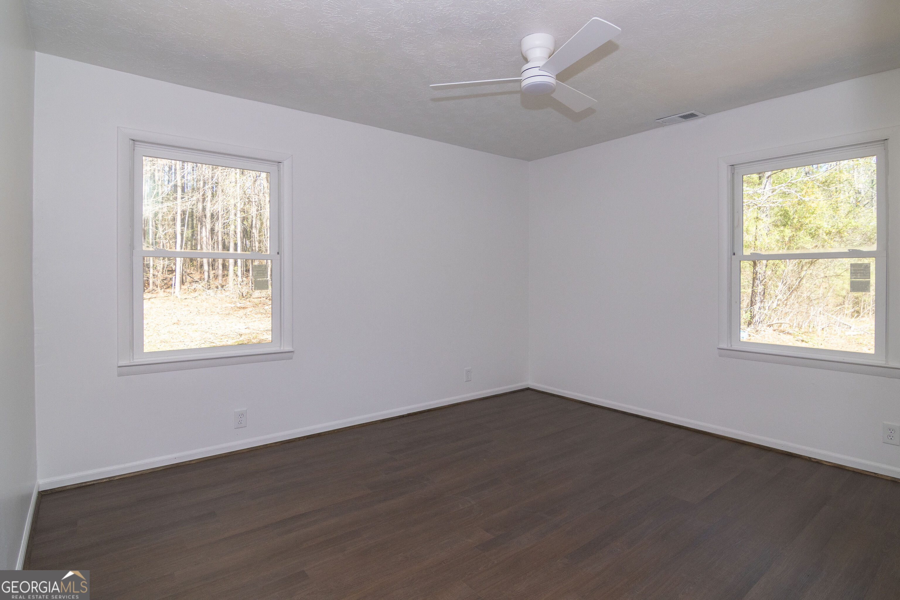 331 Deerfield Road Hogansville, GA 30230 - Photo 38 of 62 a view of an empty room with wooden floor and a window