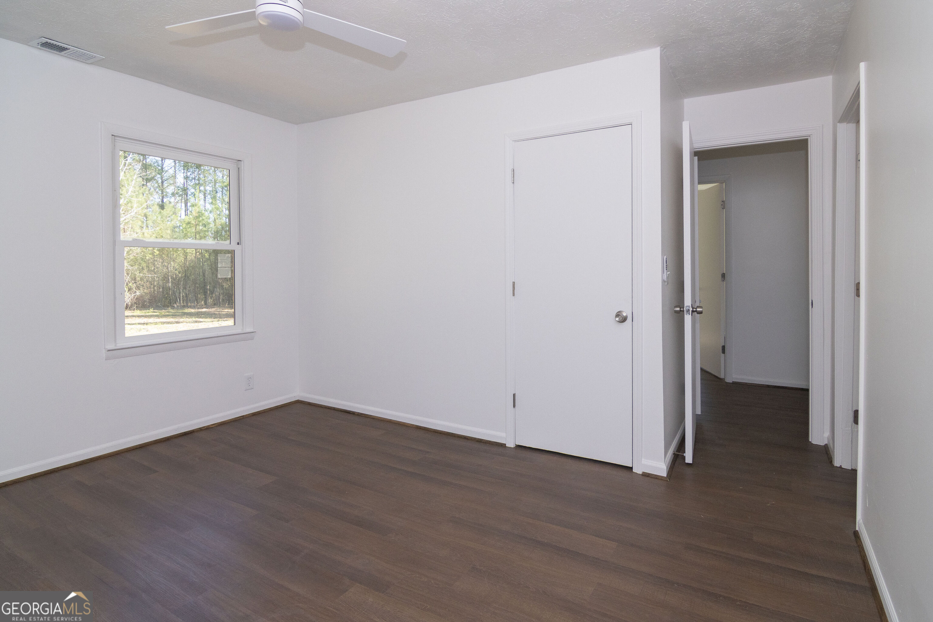 331 Deerfield Road Hogansville, GA 30230 - Photo 40 of 62 an empty room with wooden floor and windows