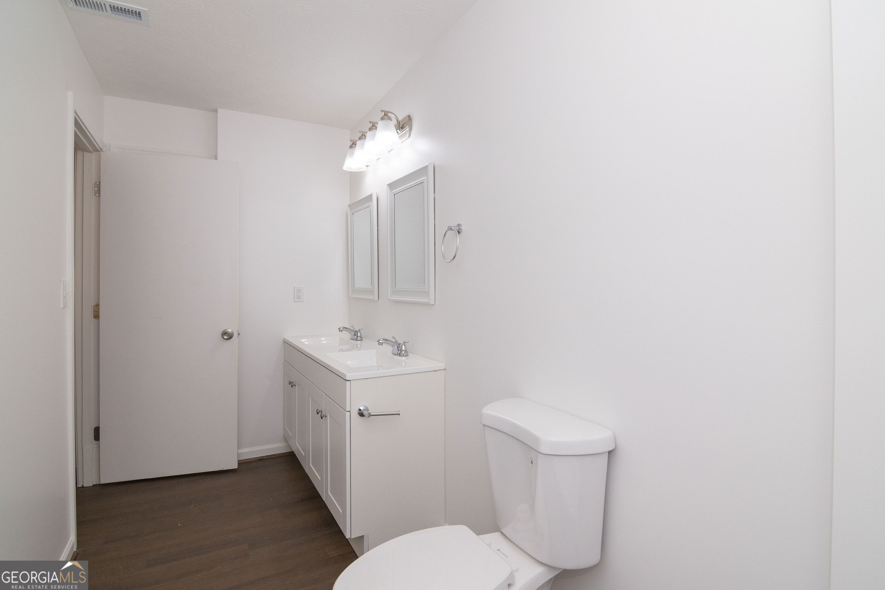 331 Deerfield Road Hogansville, GA 30230 - Photo 43 of 62 a bathroom with a toilet a sink and mirror