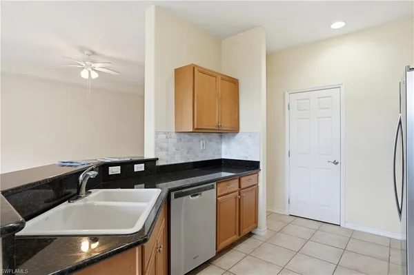 a kitchen that has a sink a stove and a refrigerator