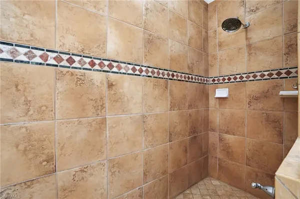 a bathroom with a double vanity sink mirror and shower
