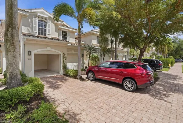 a front view of a house with parking space
