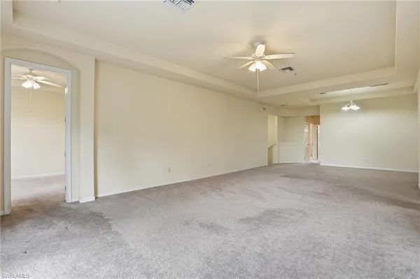 a view of a livingroom with a ceiling fan and window